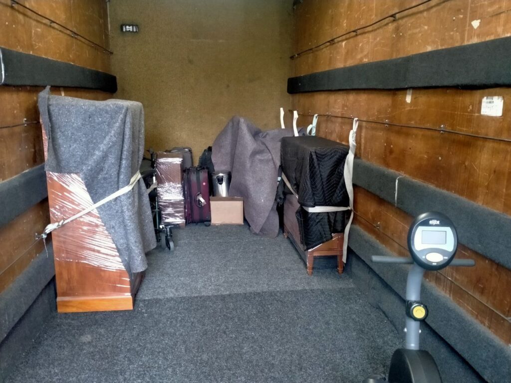 Some Furniture securely tied to the walls on the inside of an Auckland moving Guys moving truck